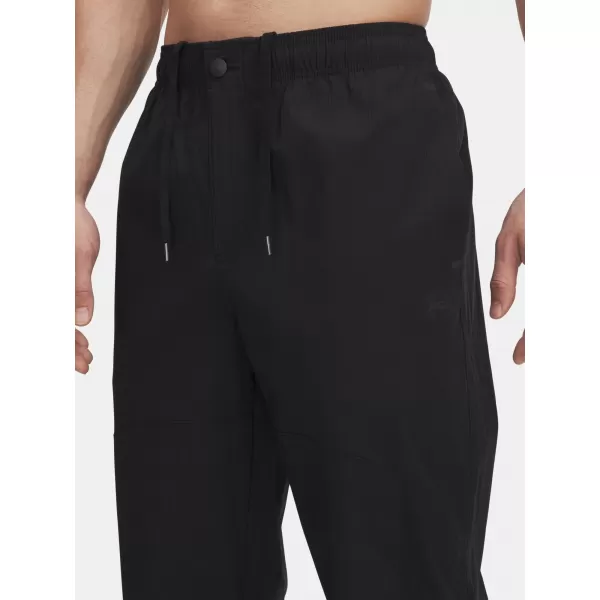 Pánské sportovní kalhoty UNDER ARMOUR UA UNSTPBLE WOVEN TX TAPER 6003865-001 ČERNÁ 